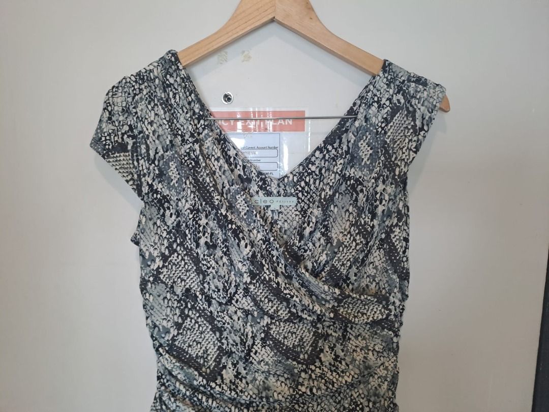 cleo petite python dress (Category: Dresses) located in Mandaluyong City. Submitted by epicowl-c93c (Listing ID 1461768605, Image 3). Description: The image shows a grey and black snakeskin python print faux wrap dress from the brand Cleo Petites. It features a V-neckline, cap sleeves, a gathered draped front, and side ruching..