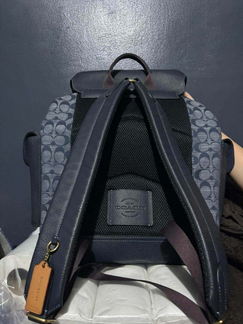 Coach Backpack Navy Blue Signature Print Leather Trim (Category: Backpacks) located in Paranaque City. Submitted by jadedazo5511744 (Listing ID 1461615526, Image 2). Description: - Navy blue Coach backpack - Signature C print on front and sides - Genuine leather trim and straps - Secure drawstring closure under flap - Elegant gold hardware details - Padded straps for maximum comfort - Ideal for everyday use or travel adventures -comes with dust b
