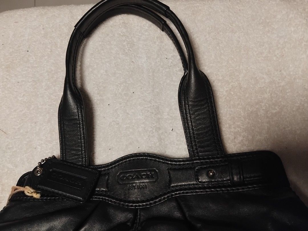 Coach Black Leather Shoulder Bag (Category: Luxury Bags & Wallets) located in Manila. Submitted by rosselegance (Listing ID 1461569333, Image 3). Description: - Authentic Coach black leather handbag - Iconic "Coach Est. 1941" embossed logo on front - Secure turn-lock closure - Elegant silver hardware - Interior zip pocket and slip pocket for organization - Spacious main compartment - Comfortable top handles for easy carrying.