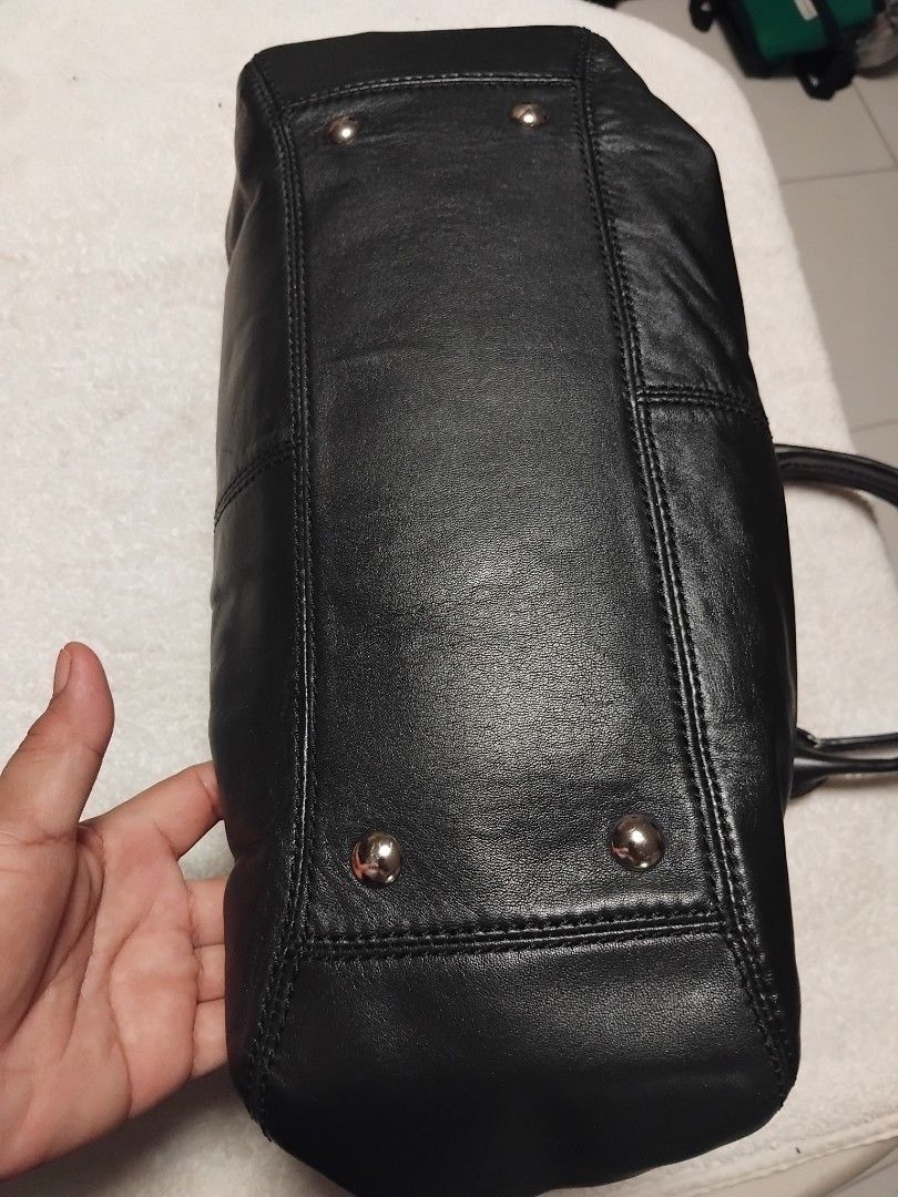 Coach Black Leather Shoulder Bag (Category: Luxury Bags & Wallets) located in Manila. Submitted by rosselegance (Listing ID 1461569333, Image 2). Description: - Authentic Coach black leather handbag - Iconic "Coach Est. 1941" embossed logo on front - Secure turn-lock closure - Elegant silver hardware - Interior zip pocket and slip pocket for organization - Spacious main compartment - Comfortable top handles for easy carrying.