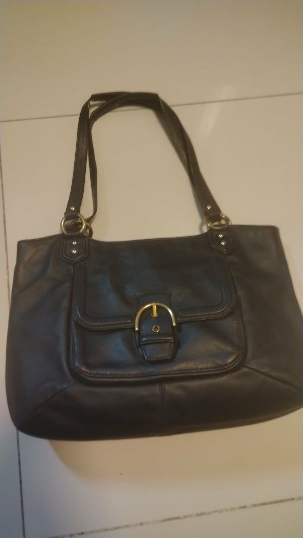Coach Black Leather Shoulder Bag (Category: Tote Bags) located in Manila. Submitted by wildwind_73f77a (Listing ID 1461587320, Image 1). Description: - Classic navy blue Coach leather shoulder bag - Features a gold buckle detail on the front pocket - Spacious interior for all your essentials - Comfortable straps for easy carrying - Ideal for everyday use - Shows some signs of wear, but plenty of life left.