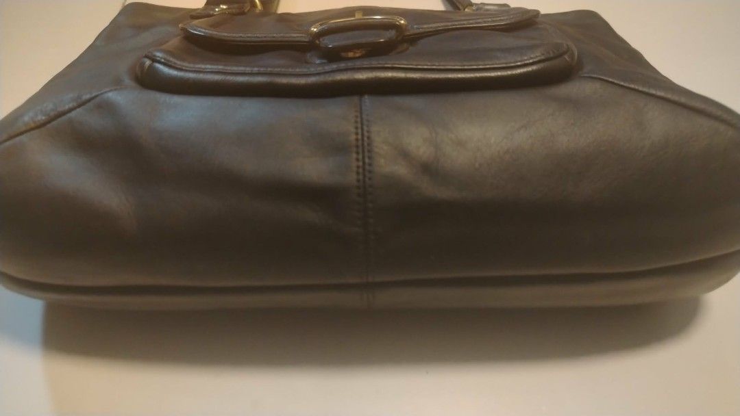 Coach Black Leather Shoulder Bag (Category: Tote Bags) located in Manila. Submitted by wildwind_73f77a (Listing ID 1461587320, Image 3). Description: - Classic navy blue Coach leather shoulder bag - Features a gold buckle detail on the front pocket - Spacious interior for all your essentials - Comfortable straps for easy carrying - Ideal for everyday use - Shows some signs of wear, but plenty of life left.
