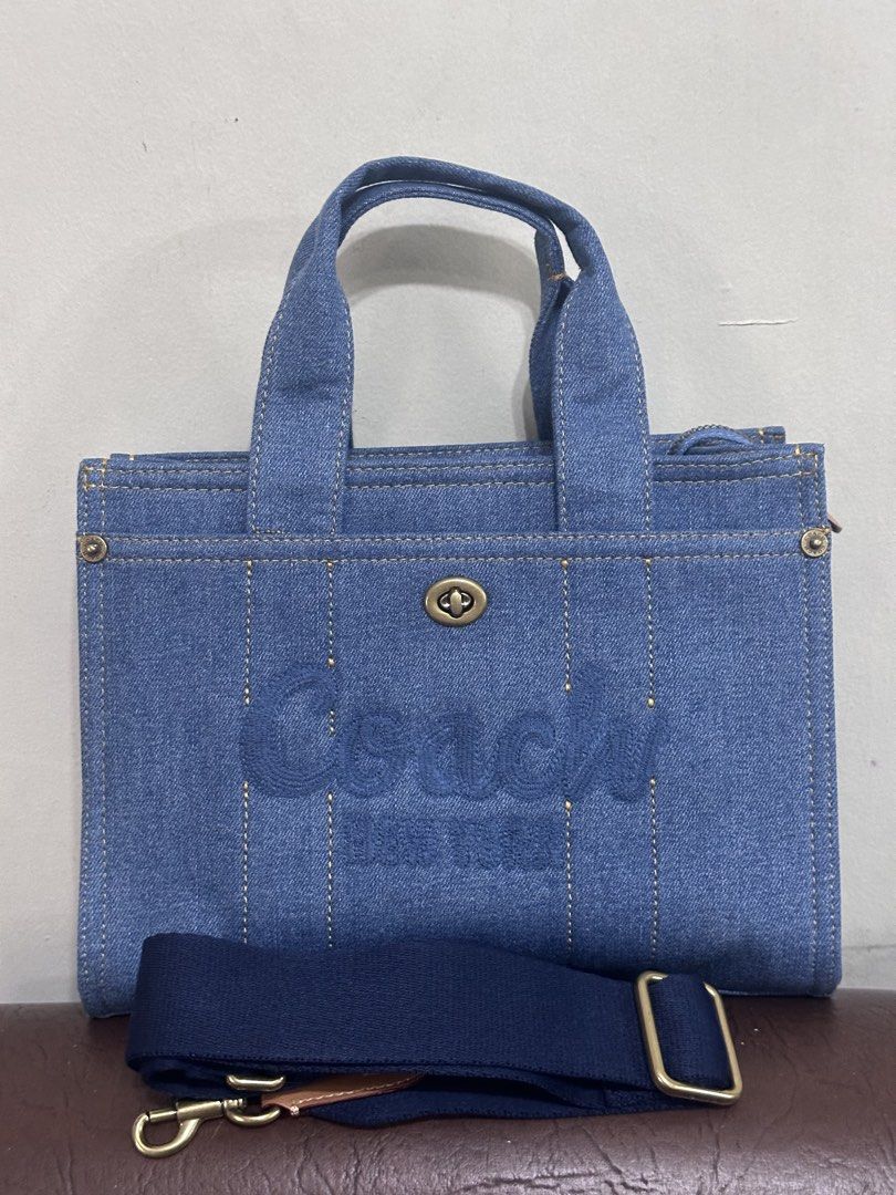 Coach Cargo Denim Tote Bag (Category: Luxury Bags & Wallets) located in Manila. Submitted by shopaholic_gurl (Listing ID 1460143107, Image 3). Description: - High Quality Coach denim tote bag -Medium size - Features iconic Coach New York logo - Versatile with top handle and detachable shoulder strap - Includes a small leather tag - Ideal for everyday errands and style -approximately measures 10.5 x 8 inches.