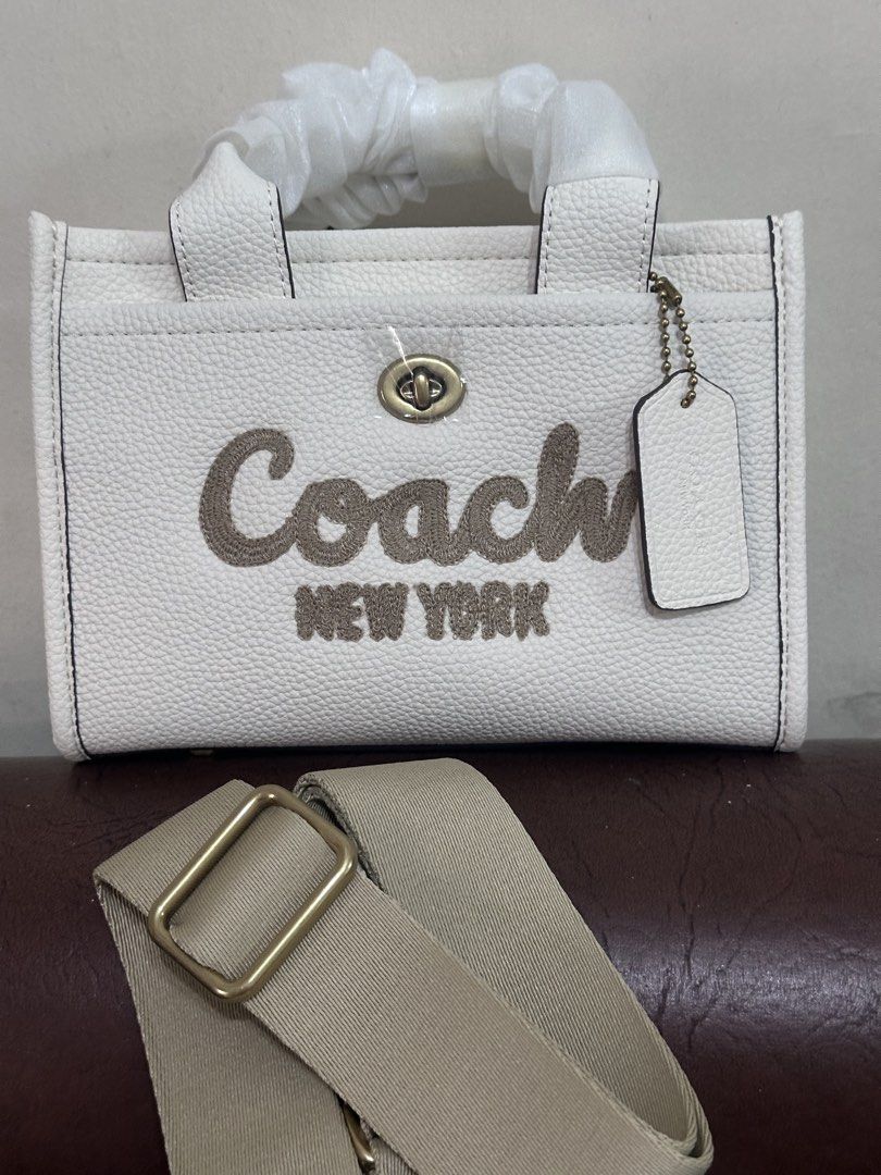 Coach cargo mini tote bag with sling (Category: Cross-body Bags) located in Manila. Submitted by shopaholic_gurl (Listing ID 1461646284, Image 2). Description: - Style: Cargo Mini Tote Bag with Sling - Color: White - Material: Pebbled Leather - Condition: New - Features: Top handles, adjustable crossbody strap, turn-lock closure, exterior pocket -high quality -sold as is.