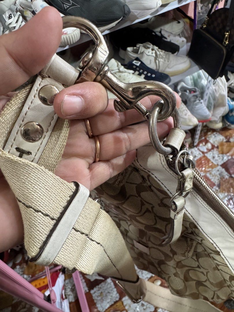 Coach Monogram Canvas Leather Shoulder Bag (Category: Luxury Bags & Wallets) located in Manila. Submitted by wildbear.e10374 (Listing ID 1461594283, Image 2). Description: - Classic Coach monogram canvas shoulder bag - White leather trim and strap details - Front pocket with snap closure - Adjustable strap with buckle - Top zipper closure - Interior likely has pockets - Great everyday bag.