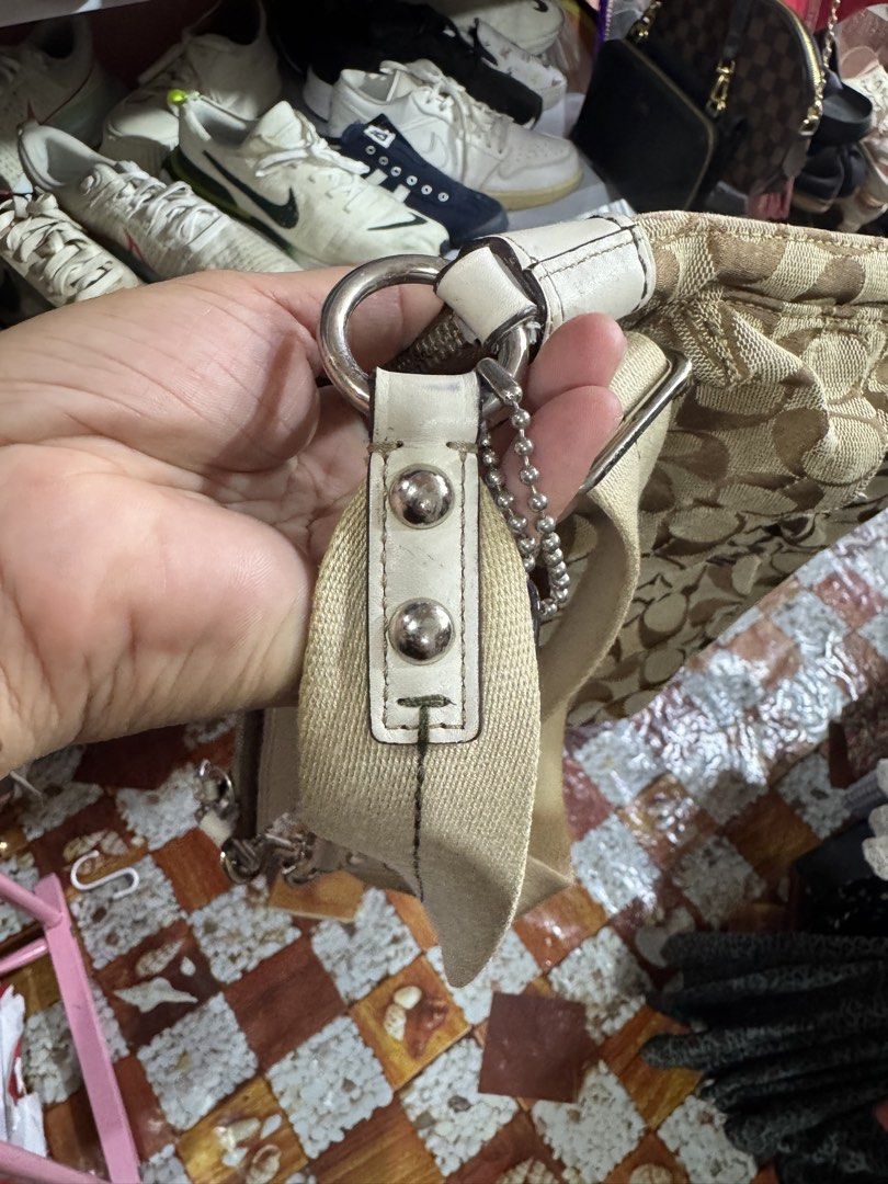 Coach Monogram Canvas Leather Shoulder Bag (Category: Luxury Bags & Wallets) located in Manila. Submitted by wildbear.e10374 (Listing ID 1461594283, Image 3). Description: - Classic Coach monogram canvas shoulder bag - White leather trim and strap details - Front pocket with snap closure - Adjustable strap with buckle - Top zipper closure - Interior likely has pockets - Great everyday bag.