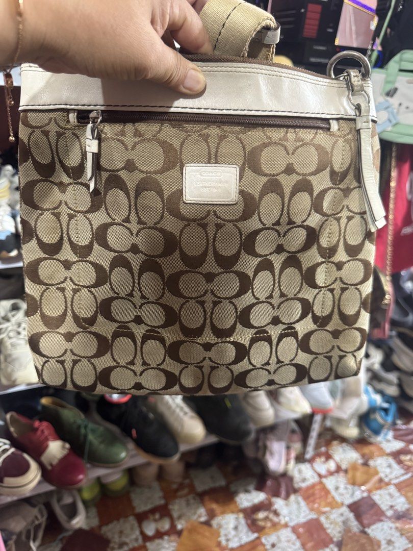 Coach Monogram Canvas Leather Shoulder Bag (Category: Luxury Bags & Wallets) located in Manila. Submitted by wildbear.e10374 (Listing ID 1461594283, Image 1). Description: - Classic Coach monogram canvas shoulder bag - White leather trim and strap details - Front pocket with snap closure - Adjustable strap with buckle - Top zipper closure - Interior likely has pockets - Great everyday bag.