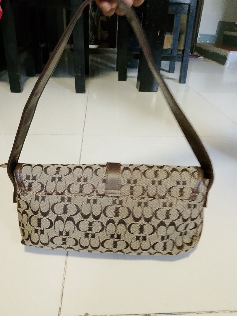 Coach Monogram Shoulder Bag Brown Canvas Leather Trim (Category: Shoulder Bags) located in Manila. Submitted by wildwind_73f77a (Listing ID 1461602331, Image 2). Description: - Coach shoulder bag in brown canvas - Signature Coach monogram pattern - Genuine leather trim and adjustable strap - Secure top zipper closure - Interior: 1 zippered pocket, 1 snap closure pocket - Front flap with decorative buckle detail - Dimensions: Approximately 12 inch