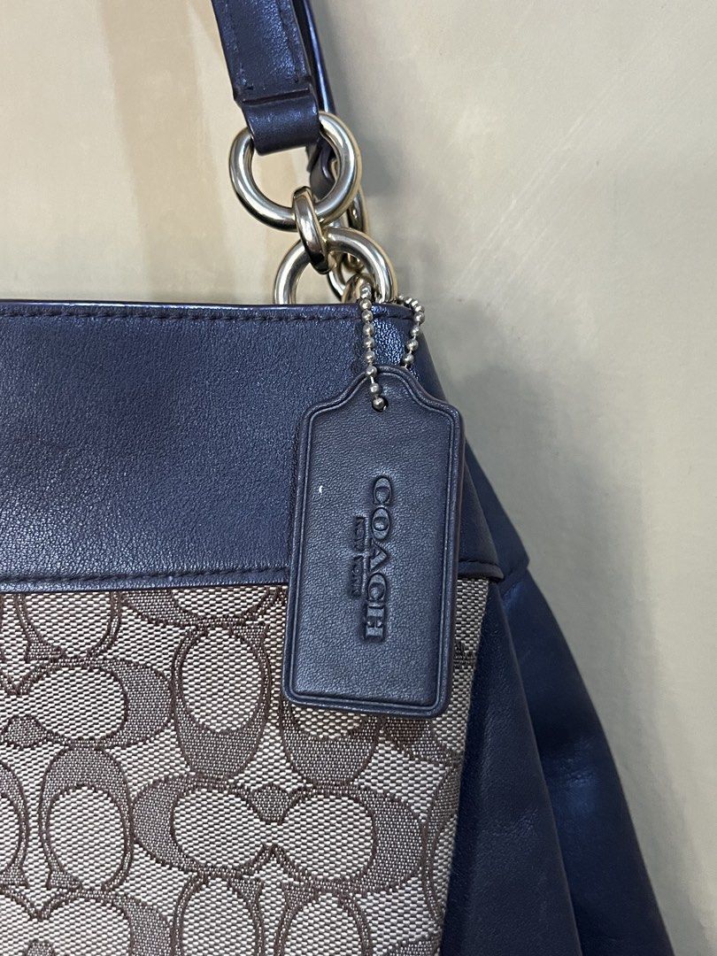 Coach Signature Canvas Leather Shoulder Bag (Category: Luxury Bags & Wallets) located in Quezon City. Submitted by kikays0215 (Listing ID 1461714564, Image 2). Description: - Classic Coach shoulder bag - Signature canvas with dark blue leather trim - Gold hardware details - Interior zip pocket and slip pockets - Spacious interior - Great everyday bag.