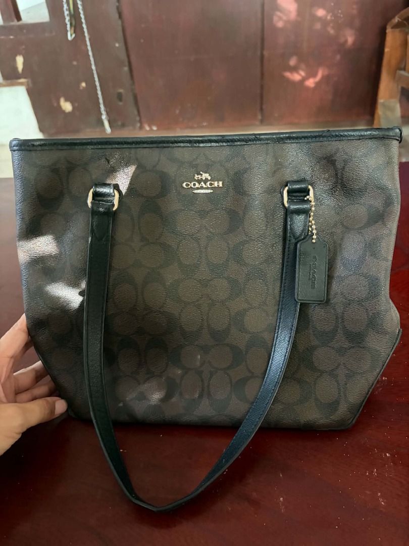 Coach Signature Canvas Tote (Category: Luxury Bags & Wallets) located in Paete. Submitted by rjpo18 (Listing ID 1461710689, Image 3). Description: Coach Signature Tote Bag Brand: Coach Style: Signature Canvas Tote / Shoulder Tote Color: Brown/Black Signature Material: Coated canvas with leather trim Hardware: Gold-tone Canvas Tote This is a pre owned bag. Authentic..
