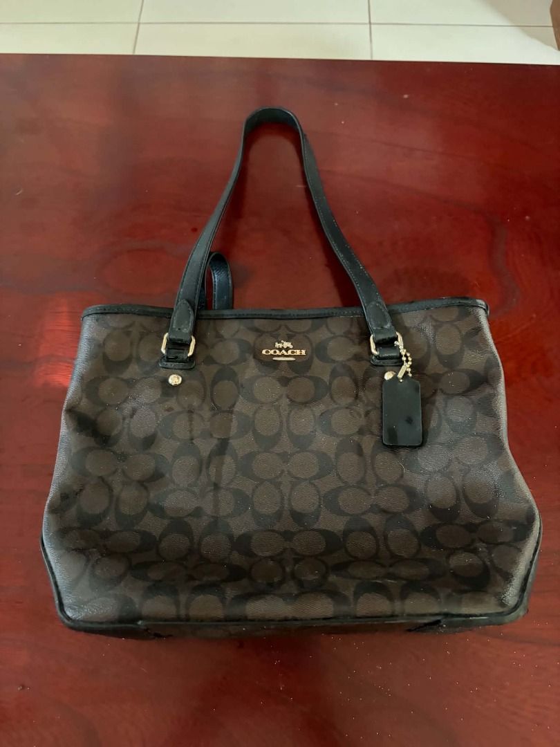 Coach Signature Canvas Tote (Category: Luxury Bags & Wallets) located in Paete. Submitted by rjpo18 (Listing ID 1461710689, Image 2). Description: Coach Signature Tote Bag Brand: Coach Style: Signature Canvas Tote / Shoulder Tote Color: Brown/Black Signature Material: Coated canvas with leather trim Hardware: Gold-tone Canvas Tote This is a pre owned bag. Authentic..