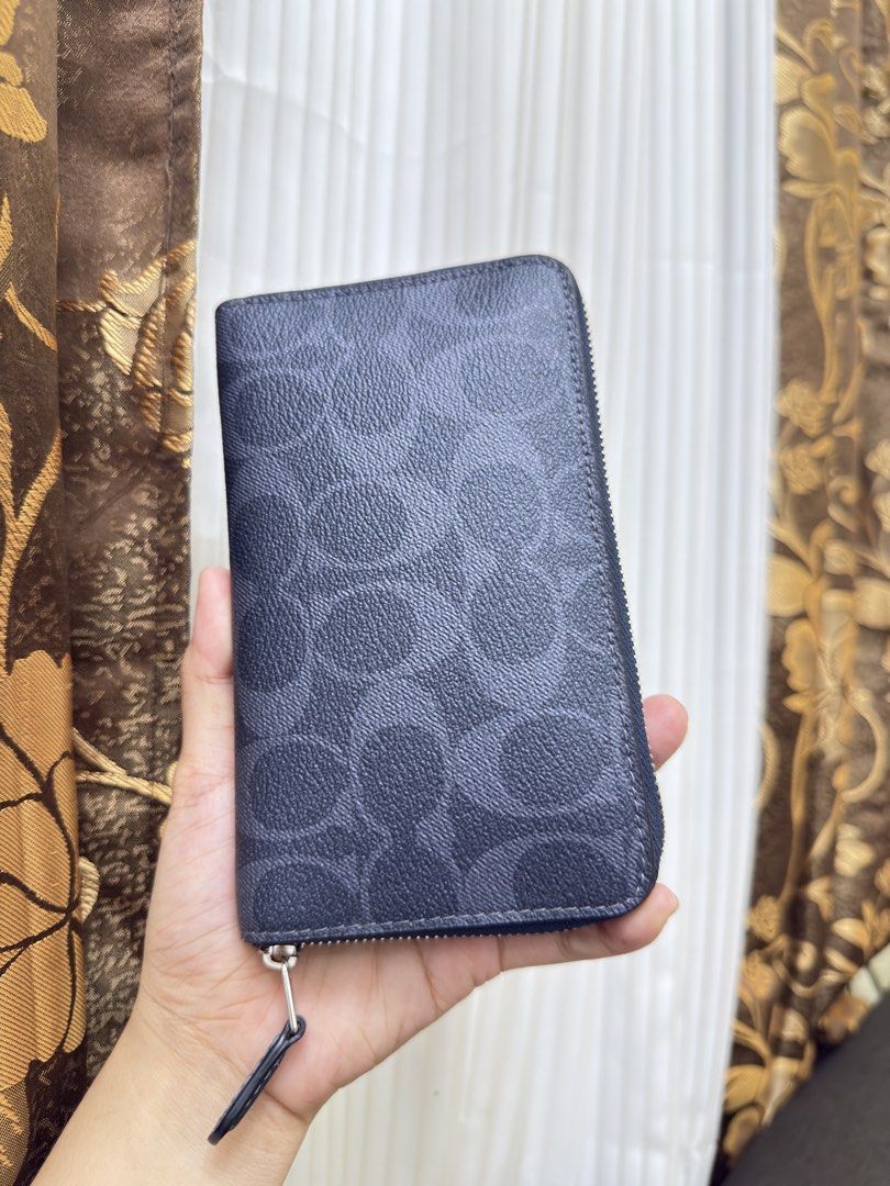 Coach Signature Medium ID Zip Around Wallet (Category: Wallets & Card holders) located in Manila. Submitted by manghobu (Listing ID 1461706342, Image 3). Description: 2 months lang nagamit W/ box and tag 5k orig price - Coach zip around wallet - Signature C pattern - Dark navy color with silver hardware - Multiple card slots and clear ID window - Secure zipper closure - Perfect for daily use or travel - Approximate dimensions: 8 inches x 4 inches