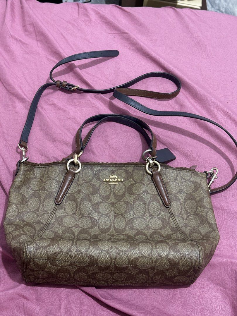 Coach Signature Monogram Satchel Bag (Category: Luxury Bags & Wallets) located in Bauang. Submitted by jeneefromtheblock (Listing ID 1461774163, Image 1). Description: - Brown Coach satchel bag - Signature Coach monogram print - Elegant gold hardware details - Multiple interior pockets for easy organization - Includes a detachable crossbody strap for versatile wear - Noted minor wear on the edge of the strap and zipper pull - Ideal everyday bag f