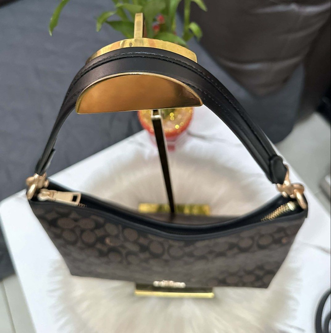 Coach Signature Monogram Shoulder Bag with Strap (Category: Luxury Bags & Wallets) located in Cebu City. Submitted by ludz_0246_2.0 (Listing ID 1461726075, Image 3). Description: - Classic Coach signature monogram print - Color: Dark brown and tan - Detachable crossbody strap included - Interior: 1 zip pocket, slip pockets - Gold hardware details - Ideal for everyday use.