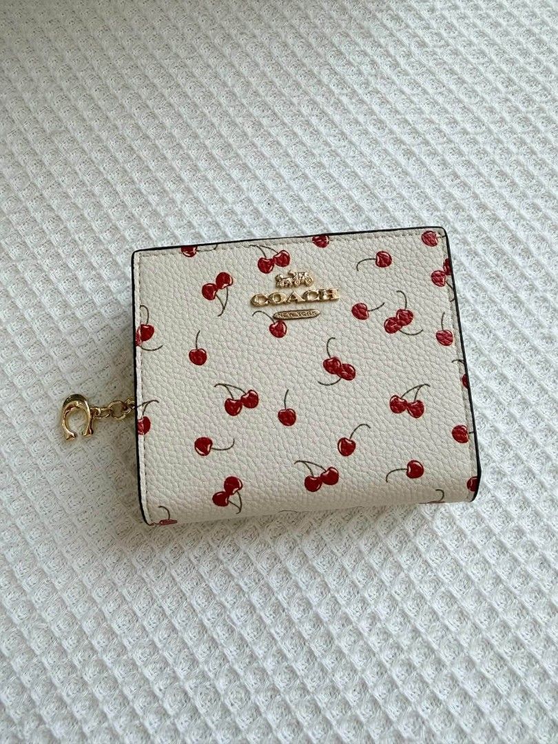 Coach Snap Bifold Wallet with Cherry Print (Category: Wallets & Card holders) located in Quezon City. Submitted by bagsboutiqueph (Listing ID 1461728511, Image 1). Description: LAST PRICE POSTED. LIMITED STOCKS! BRANDNEW WITH INCLUSIONS. COLOR MAY SLIGHTLY VARY IN ACTUAL DUE TO LIGHTING AND CAMERA SETTING. OTHER PHOTOS WILL BE SEND DURING PURCHASE AND FOR SURE BUYERS ONLY. WHEN IN DOUBT, DO NOT ORDER. THANK YOU..