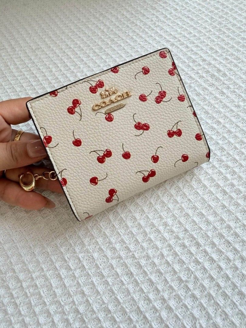 Coach Snap Bifold Wallet with Cherry Print (Category: Wallets & Card holders) located in Quezon City. Submitted by bagsboutiqueph (Listing ID 1461728511, Image 2). Description: LAST PRICE POSTED. LIMITED STOCKS! BRANDNEW WITH INCLUSIONS. COLOR MAY SLIGHTLY VARY IN ACTUAL DUE TO LIGHTING AND CAMERA SETTING. OTHER PHOTOS WILL BE SEND DURING PURCHASE AND FOR SURE BUYERS ONLY. WHEN IN DOUBT, DO NOT ORDER. THANK YOU..