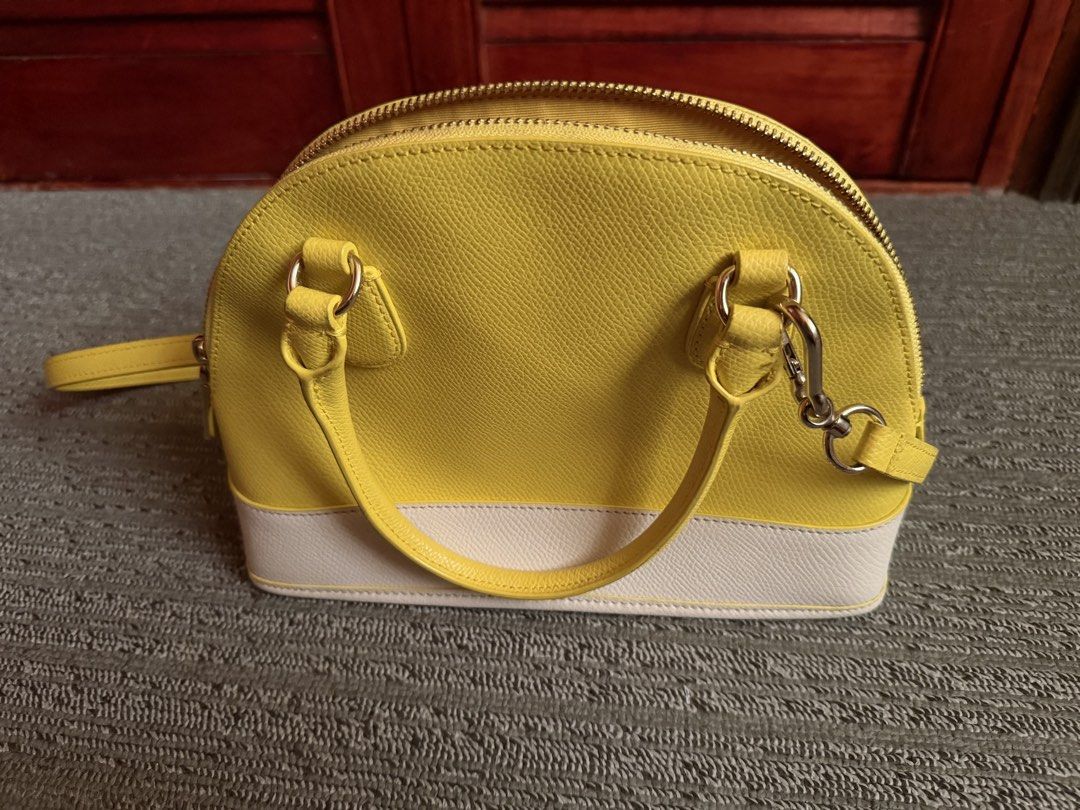 Coach Yellow/White Mini Cora Domed (Category: Cross-body Bags) located in San Juan, Ilocos Sur. Submitted by swiftfire.f9f998 (Listing ID 1461576968, Image 3). Description: Brand new Mini Cora Domed Yellow/White color Dual top handles Detachable shoulder strap.