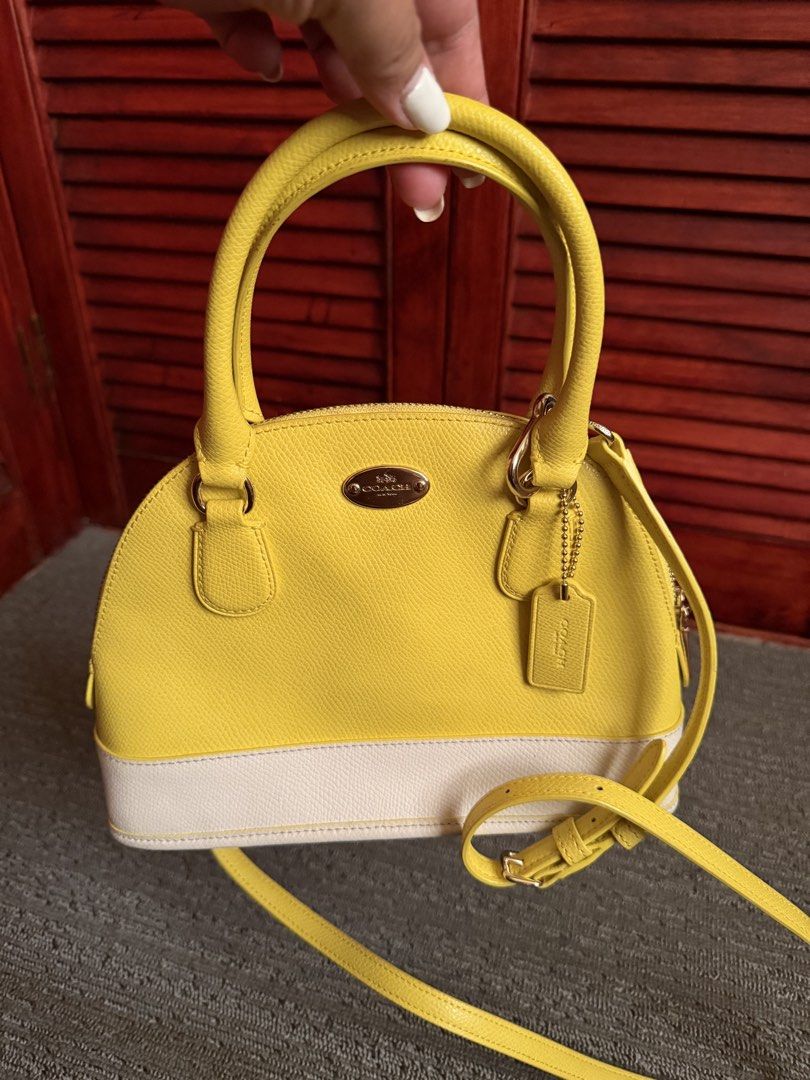 Coach Yellow/White Mini Cora Domed (Category: Cross-body Bags) located in San Juan, Ilocos Sur. Submitted by swiftfire.f9f998 (Listing ID 1461576968, Image 1). Description: Brand new Mini Cora Domed Yellow/White color Dual top handles Detachable shoulder strap.