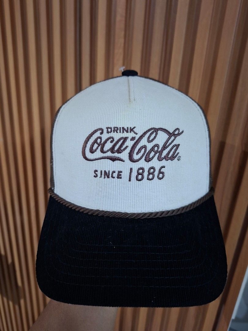 Coca-Cola "Since 1886" Trucker Cap (Category: Caps & Hats) located in Cebu City. Submitted by anton_delos_reyes (Listing ID 1461596988, Image 1). Description: - Classic Coca-Cola cap - Embroidered 'Drink Coca-Cola Since 1886' logo on front - White corduroy front panel - Black corduroy sides and brim - Breathable mesh back - Adjustable snapback closure - Ideal for Coca-Cola fans and collectors.
