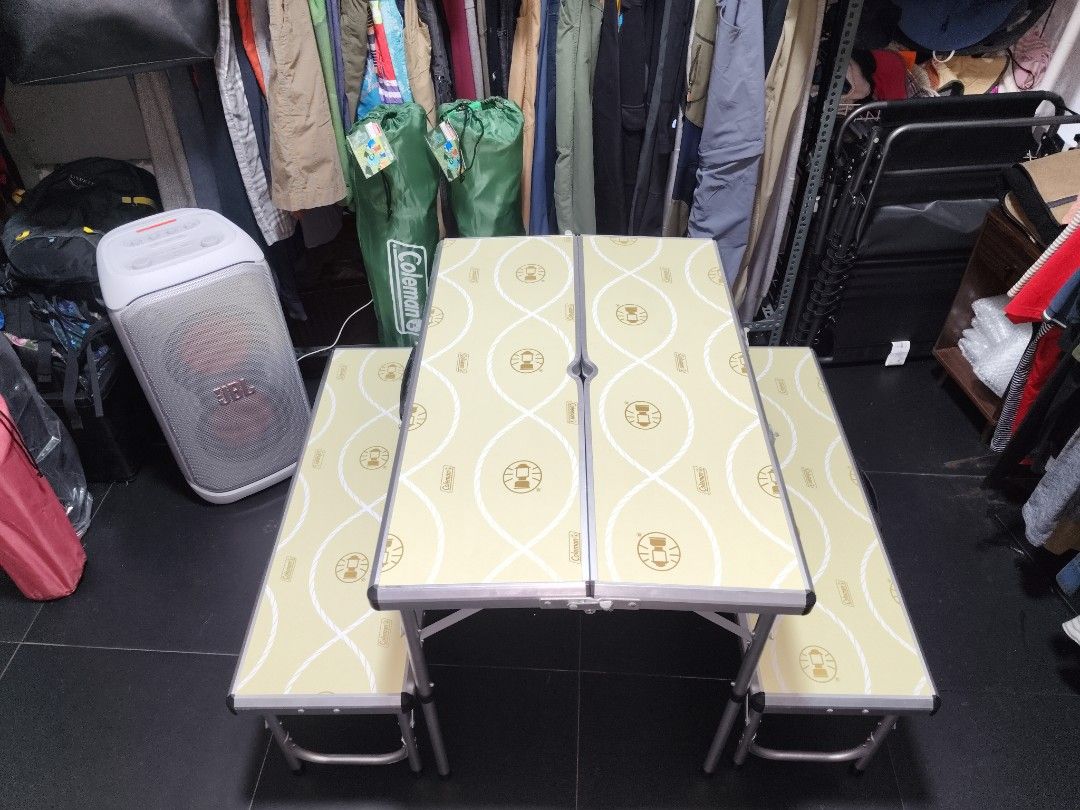 Coleman Folding Picnic Table with Benches (Category: Outdoor Furniture) located in San Juan City. Submitted by swiftfox.62e2f4 (Listing ID 1461685883, Image 1). Description: - Portable and folding picnic table set by Coleman - Includes two attached benches - Folds compactly for easy storage and transport - Features a light yellow tabletop and benches with a rope and logo pattern - Built-in handle for convenient carrying - Ideal for outdoor gather