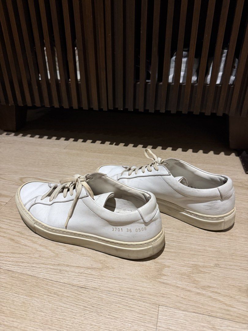 Common Projects White Leather Sneakers (Category: Sneakers) located in San Juan City. Submitted by tanyasthings (Listing ID 1461719641, Image 1). Description: - Classic white leather sneakers - Brand: Common Projects - Signature serial number stamped on heel - Versatile for everyday wear - Soles show some signs of use, with plenty of life left - Comes with original laces.