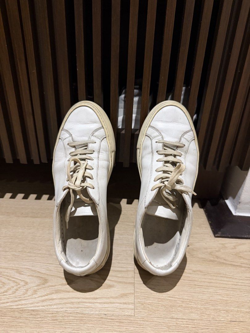 Common Projects White Leather Sneakers (Category: Sneakers) located in San Juan City. Submitted by tanyasthings (Listing ID 1461719641, Image 3). Description: - Classic white leather sneakers - Brand: Common Projects - Signature serial number stamped on heel - Versatile for everyday wear - Soles show some signs of use, with plenty of life left - Comes with original laces.