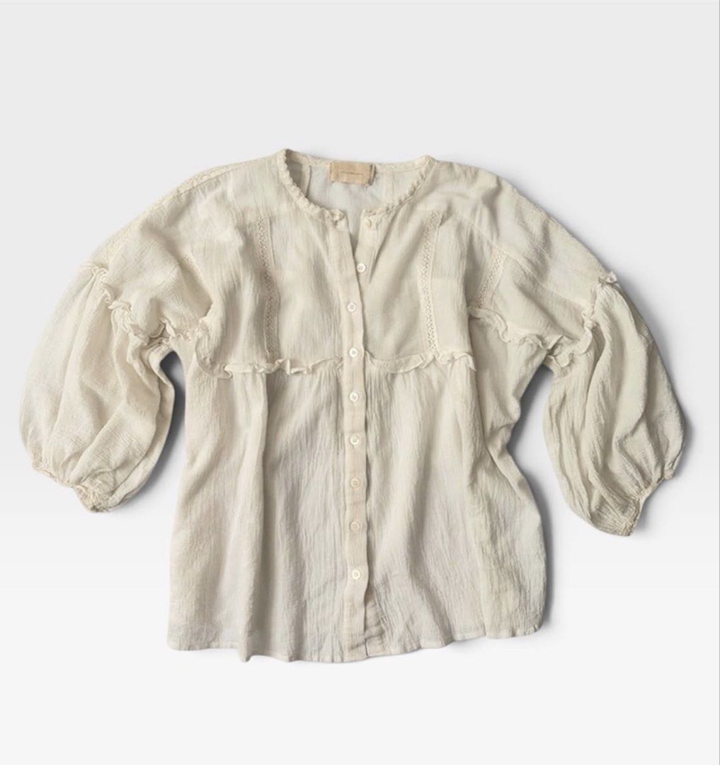 Cottage-core Blouse (Category: Blouses) located in Makati City. Submitted by jjnsn (Listing ID 1461581841, Image 2). Description: White textured blouse with lace and ruffles. Button-up, round neck, flowy fit, 3/4 sleeves with elastic cuffs. Could fit M-L.