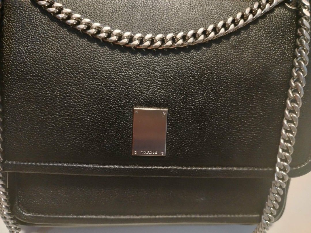 Couronne Black Leather Chain Shoulder Bag (Category: Shoulder Bags) located in Manila. Submitted by wildwind_73f77a (Listing ID 1461585493, Image 3). Description: - Brand: Couronne - Material: Black Leather - Strap: Silver Chain - Closure: Magnetic flap - Interior: Main compartment, zippered pocket - Condition: Clean interior - Best for: Everyday use.