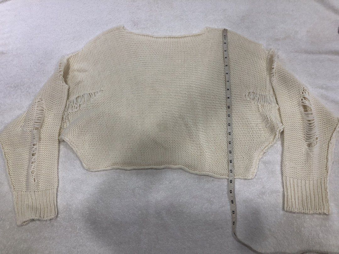 Cream Distressed Knit Cropped Sweater (Category: Longsleeves) located in Manila. Submitted by janmichael26601 (Listing ID 1461591447, Image 1). Description: - Cream knit sweater - Cropped style - Distressed details on sleeves and hem - Estimated size: Medium - Measurements: Chest approx. 20 inches, Length approx. 18 inches - Ideal for layering or casual outfits.