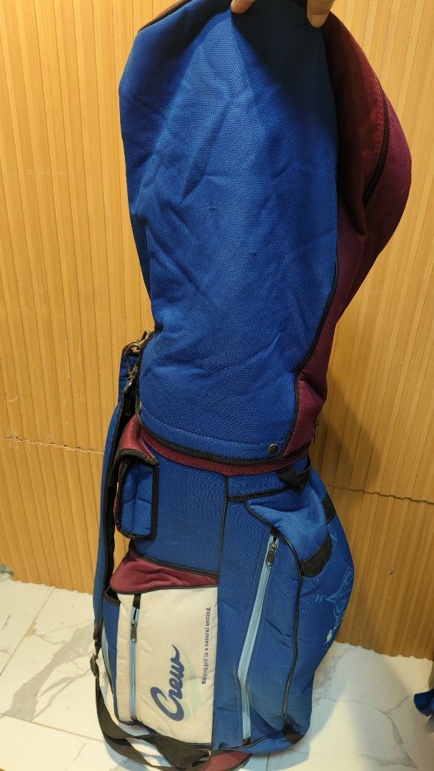 Crew Golf Bag - Blue, Burgundy, Cream (Category: Golf) located in Bulacan. Submitted by babz30261 (Listing ID 1461644218, Image 3). Description: - Stylish blue and burgundy golf bag with cream accents. - Features the 'Crew' logo and 'Enjoying golf in a natural setting' text. - Multiple zippered pockets for ample storage. - Includes a convenient shoulder strap. - Ideal for safely and easily carrying your golf clubs..