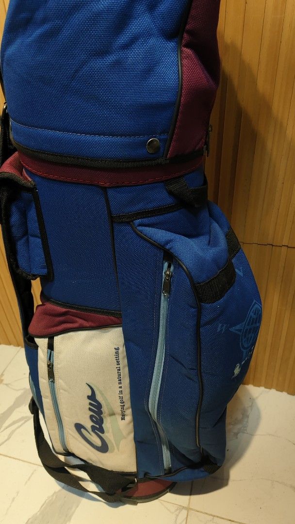 Crew Golf Bag - Blue, Burgundy, Cream (Category: Golf) located in Bulacan. Submitted by babz30261 (Listing ID 1461644218, Image 1). Description: - Stylish blue and burgundy golf bag with cream accents. - Features the 'Crew' logo and 'Enjoying golf in a natural setting' text. - Multiple zippered pockets for ample storage. - Includes a convenient shoulder strap. - Ideal for safely and easily carrying your golf clubs..