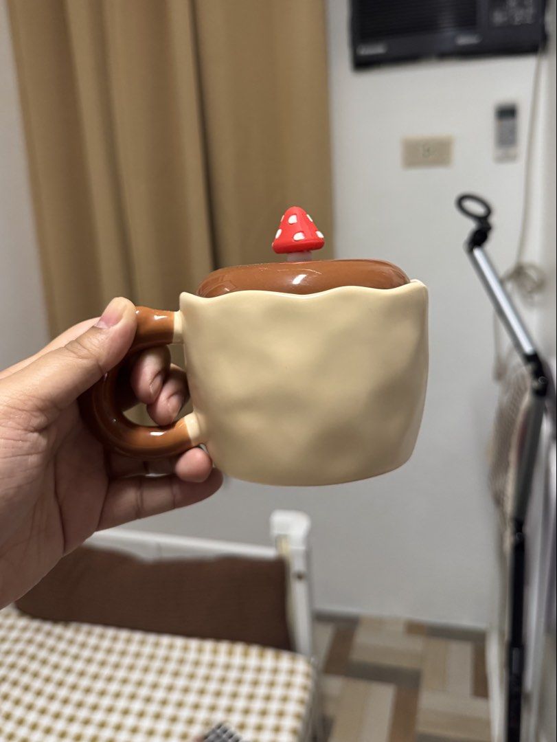 Cute Mushroom Ceramic Mug with Lid (Category: Coffee & Tea Tableware) located in Calamba. Submitted by keemi_ (Listing ID 1461738107, Image 2). Description: - ₱270 - Ceramic mug with lid - Light beige color - Warm brown handle - Ideal for morning coffee or tea. - Makes a great gift.