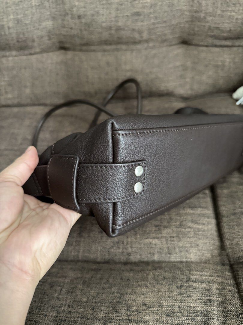 Dark Brown Leather Shoulder Bag (Category: Luxury Bags & Wallets) located in Taguig. Submitted by preloved_bycarla (Listing ID 1461610672, Image 3). Description: - Classic dark brown leather shoulder bag - Secure zip closure on top - Multiple interior pockets, including a zippered one - Comfortable shoulder straps - Simple and functional design - Ideal for everyday use Bought from CMG Powerplant Mall. Genuine leather. Barely used just stored. Rfs