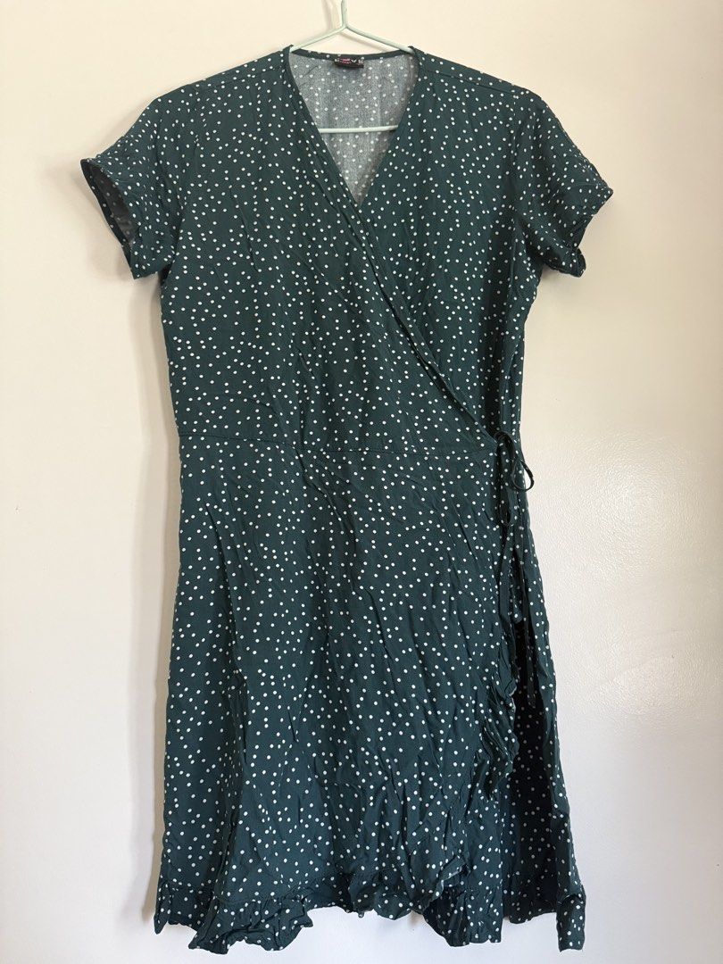 Dark Green Polka Dot Wrap Dress (Category: Dresses) located in Laoag. Submitted by rhedgejasm73385 (Listing ID 1461693435, Image 1). Description: - Adorable dark green dress with classic white polka dots. - Flattering wrap style with comfortable short sleeves. - Chic ruffled hemline for a touch of flair. - Versatile: great for casual outings or dressing up. - Easy to tie and adjust for a perfect fit..