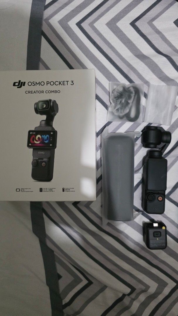DJI Osmo Pocket 3 Creator Combo (Category: Video Cameras) located in Manila. Submitted by primos_playground (Listing ID 1461758670, Image 1). Description: - DJI Osmo Pocket 3 Creator Combo PHP 23k Negotiable - Includes: Camera, Handle with Battery Extension, Wide-Angle Lens, Microphone, Carrying Case - Also includes charging cable and other accessories shown - Ideal for vlogging and content creation - All items are good as new and in the original