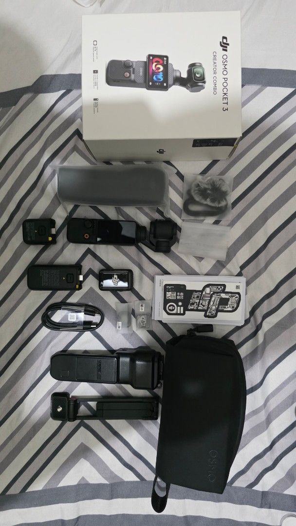 DJI Osmo Pocket 3 Creator Combo (Category: Video Cameras) located in Manila. Submitted by primos_playground (Listing ID 1461758670, Image 2). Description: - DJI Osmo Pocket 3 Creator Combo PHP 23k Negotiable - Includes: Camera, Handle with Battery Extension, Wide-Angle Lens, Microphone, Carrying Case - Also includes charging cable and other accessories shown - Ideal for vlogging and content creation - All items are good as new and in the original