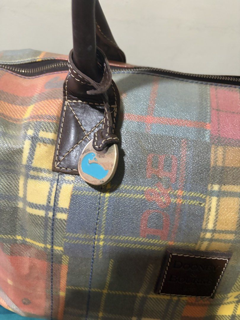 ❤️❤️❤️Dooney & Bourke Plaid Duffle Bag (Project Bag) (Category: Luxury Bags & Wallets) located in Las Pinas. Submitted by ces0427 (Listing ID 1461659565, Image 3). Description: - Cute Dooney & Bourke duffle bag - Colorful plaid pattern - Leather handles and trim - Zipper closure - Signature duck charm included - Ideal for weekend trips or carry-on luggage - Shows some wear on handles and trim, but plenty of life left. please manage your expectatı