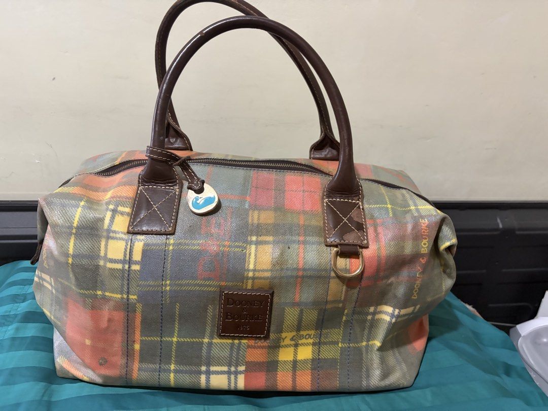 ❤️❤️❤️Dooney & Bourke Plaid Duffle Bag (Project Bag) (Category: Luxury Bags & Wallets) located in Las Pinas. Submitted by ces0427 (Listing ID 1461659565, Image 2). Description: - Cute Dooney & Bourke duffle bag - Colorful plaid pattern - Leather handles and trim - Zipper closure - Signature duck charm included - Ideal for weekend trips or carry-on luggage - Shows some wear on handles and trim, but plenty of life left. please manage your expectatı