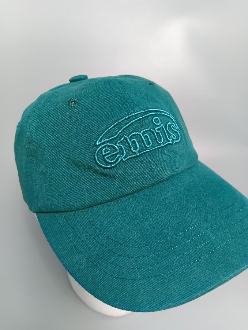 EMIS Cotton Brushed Ball Cap in Green. [ (Category: Caps & Hats) located in Manila. Submitted by hustler_777 (Listing ID 1461728413, Image 3). Description: EMIS (Every Moment Is Special) is an incredibly popular South Korean lifestyle brand frequently worn by K-pop idols and celebrities. This specific model stands out because of its unique texture and tone-on-tone coloring. Key Features Fabric Composition: Crafted from 100% premium cotton fleece.