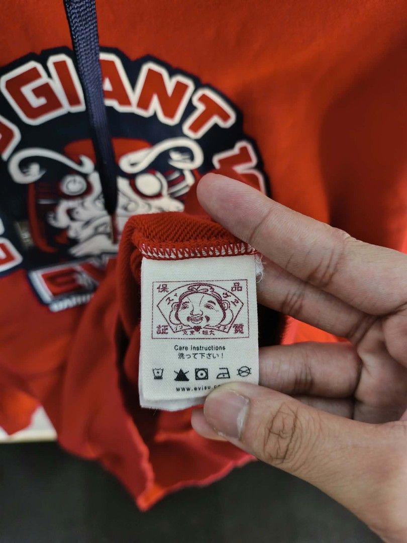 Evisu Giant Red Hoodie XL (Category: Coats, Jackets and Outerwear) located in Manila. Submitted by temetrius_husslin (Listing ID 1461744044, Image 3). Description: - Authentic Evisu Giant Hoodie - Size: XL - Bold graphic print on the front - Contrasting navy and white hood lining.