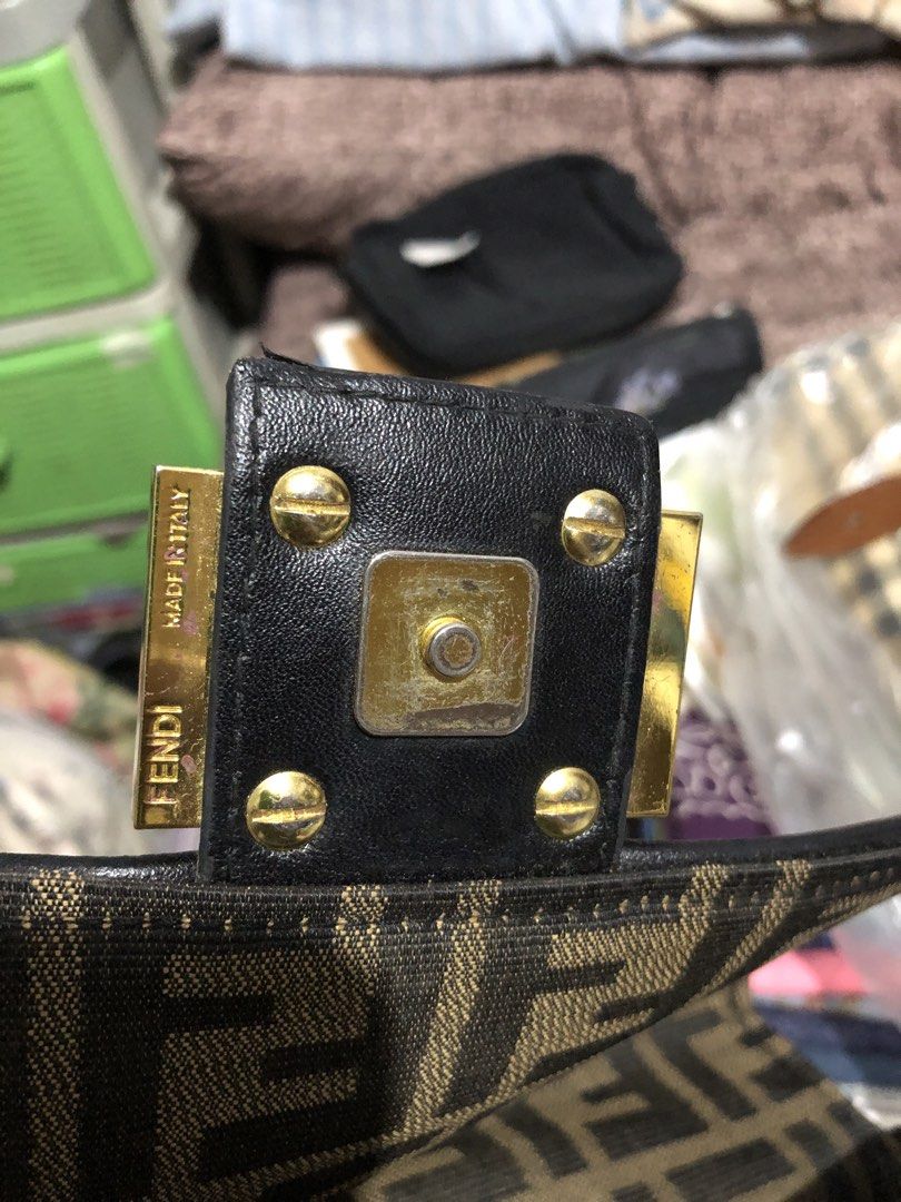 Fendi Zucca Baguette Bag (Category: Luxury Bags & Wallets) located in Quezon City. Submitted by yunajohan24 (Listing ID 1461701647, Image 3). Description: - Classic Fendi Zucca baguette bag - Brown and black canvas with leather trim - Gold hardware detail on the front - Adjustable strap - Versatile for everyday use or evening events - A timeless fashion statement.