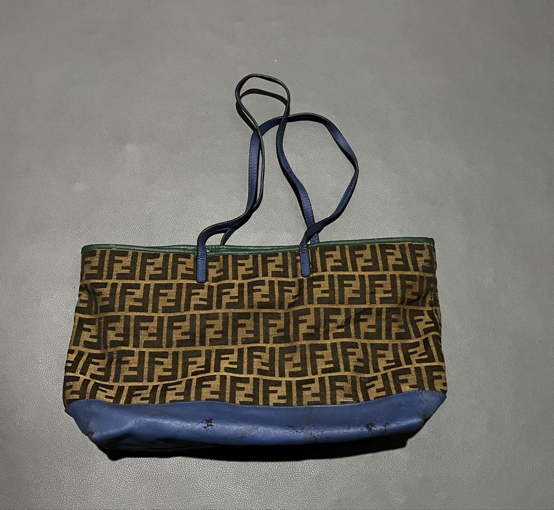 Fendi Zucca Canvas & Leather Tote Bag (Category: Tote Bags) located in General Santos City (Dadiangas). Submitted by thiftnibadi3 (Listing ID 1461694059, Image 2). Description: - Authentic Fendi tote bag - Classic Zucca canvas with blue leather accents - Interior zip closure - Made in Italy - Shows some signs of wear on leather trim and base (consistent with age/use) - Perfect everyday bag.