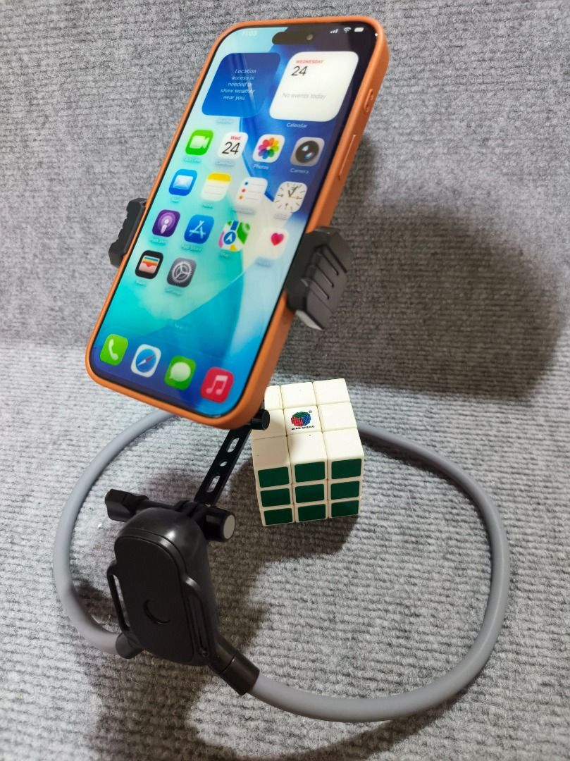 Flexible Neck-Hang Lazy Phone Mount & Desktop Stand (Category: Mounts & Holders) located in San Leonardo. Submitted by burgossanleonardo.12345 (Listing ID 1461707259, Image 1). Description: Mount Type: Spring-loaded side clamp.Material: Flexible alloy core, padded foam sleeve, and durable ABS plastic.Compatibility: Fits most standard smartphones (including iPhones and Android devices with protective cases).Color: Sleek Black mount with a minimali