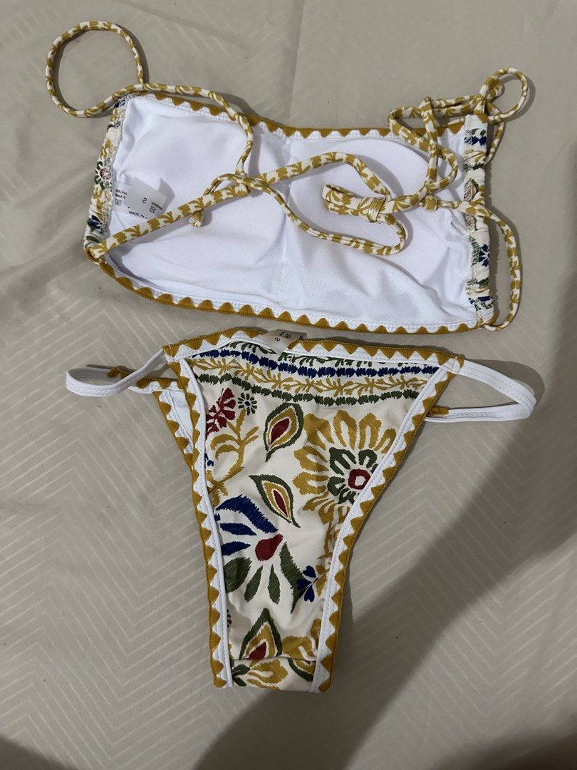 Floral Print Bikini Set with Tie Straps (Category: Bikinis & Swimsuits) located in Lipa City. Submitted by chiechums (Listing ID 1461566380, Image 2). Description: - Cute floral print bikini set - Halter neck top with adjustable tie straps - Cheeky cut bottoms - Unique pattern with yellow, blue, and red accents - Ideal for beach trips or pool days - Get ready for summer vibes!.