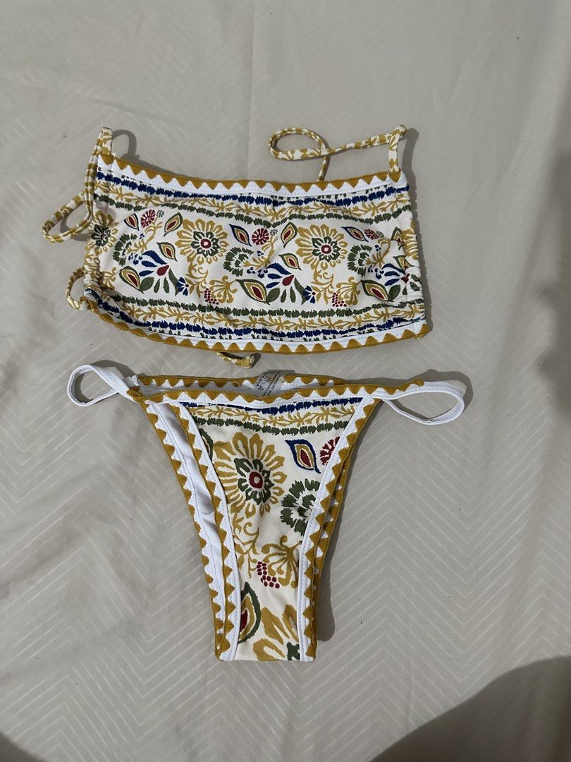 Floral Print Bikini Set with Tie Straps (Category: Bikinis & Swimsuits) located in Lipa City. Submitted by chiechums (Listing ID 1461566380, Image 1). Description: - Cute floral print bikini set - Halter neck top with adjustable tie straps - Cheeky cut bottoms - Unique pattern with yellow, blue, and red accents - Ideal for beach trips or pool days - Get ready for summer vibes!.