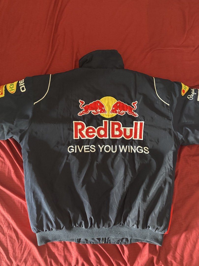 Formula 1 Red Bull Racing Bomber Jacket (Category: Coats, Jackets and Outerwear) located in Manila. Submitted by rsnebiz (Listing ID 1461586278, Image 2). Description: - Authentic Red Bull Racing jacket - Features Infiniti and Pepe Jeans branding - Adorned with sponsor logos: Geox, Total, Rauch, Pirelli, Casio - Ideal for any Formula 1 enthusiast - Zip-up front with a comfortable collar - Ribbed cuffs and hem for a snug fit - Iconic 'Red Bull Giv