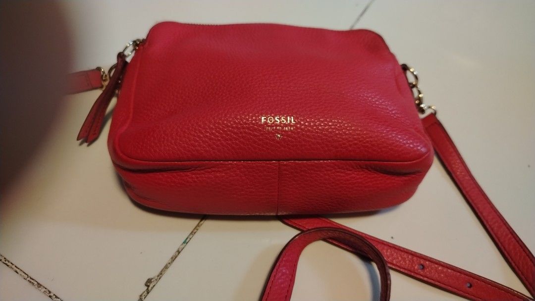 Fossil Red Leather Crossbody Bag (Category: Cross-body Bags) located in Manila. Submitted by wildwind_73f77a (Listing ID 1461570346, Image 1). Description: - Fossil red pebbled leather crossbody bag - Two zippered compartments for secure storage - Elegant gold hardware details - Adjustable strap for comfortable wear - Versatile for everyday use or a night out - Spacious interior for your essentials.