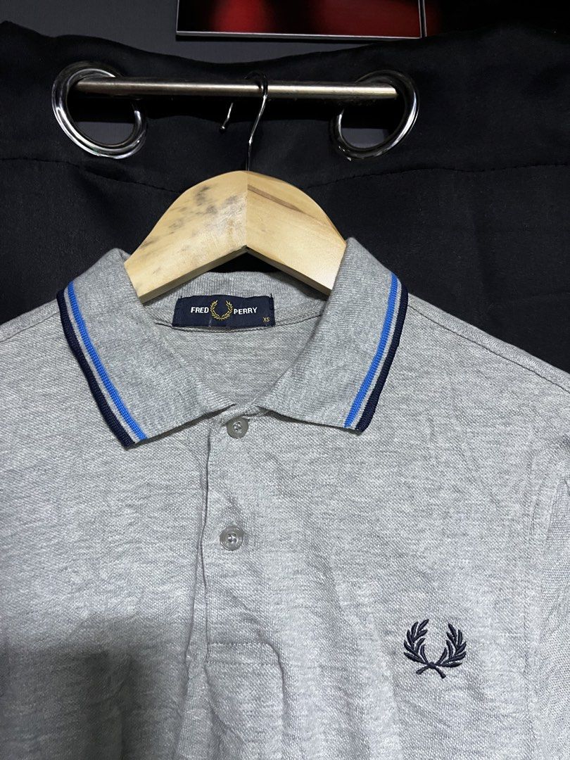 Fred Perry Grey Polo Shirt XS (Category: Tshirts & Polo Shirts ) located in Panabo. Submitted by edition_25 (Listing ID 1461665639, Image 2). Description: - Grey Fred Perry polo shirt - Iconic embroidered laurel wreath logo on chest - Blue and navy trim on collar and cuffs - Size XS - Ideal for casual wear - 18 width - 27 length - As new - No issue - 10/10.