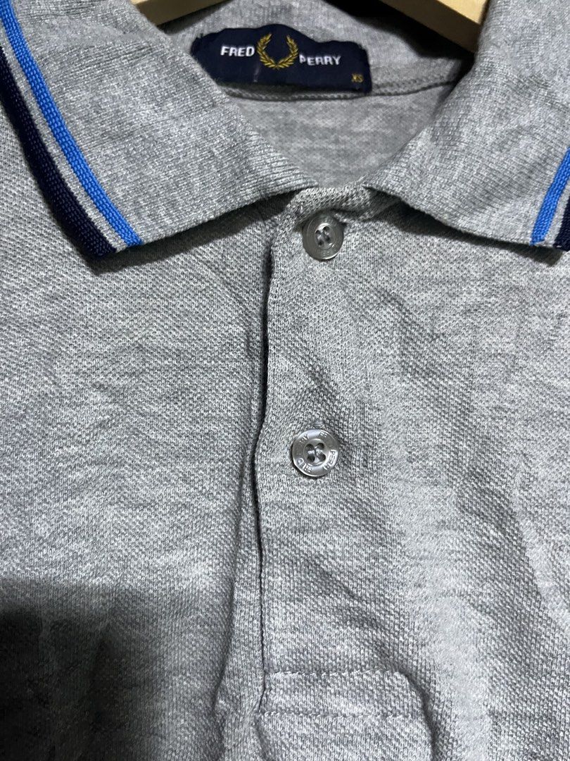 Fred Perry Grey Polo Shirt XS (Category: Tshirts & Polo Shirts ) located in Panabo. Submitted by edition_25 (Listing ID 1461665639, Image 3). Description: - Grey Fred Perry polo shirt - Iconic embroidered laurel wreath logo on chest - Blue and navy trim on collar and cuffs - Size XS - Ideal for casual wear - 18 width - 27 length - As new - No issue - 10/10.