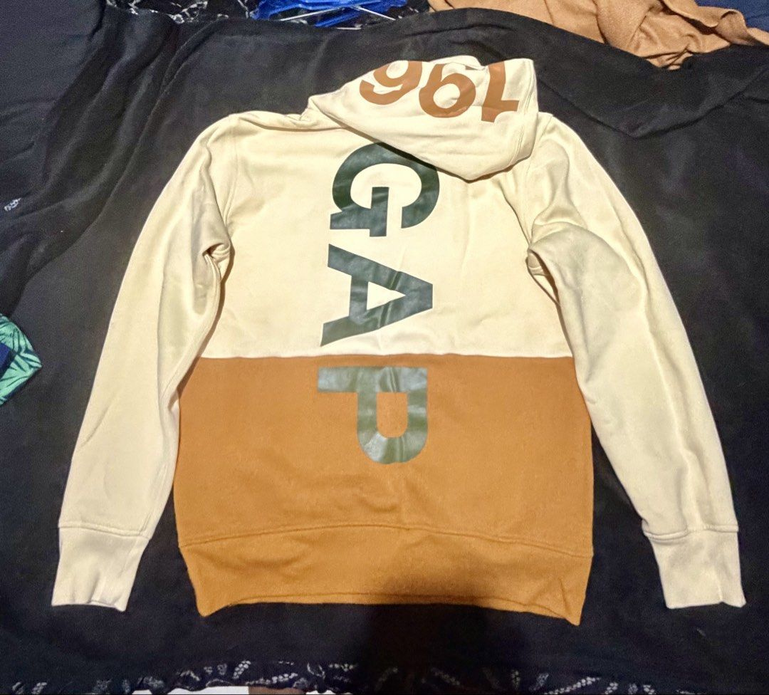 GAP Colorblock Hoodie "196" Logo (Category: Coats, Jackets and Outerwear) located in Manila. Submitted by jayveepas (Listing ID 1461668628, Image 3). Description: - GAP cream and tan colorblock hoodie - Features 'GAP' logo vertically on the back - '196' detail on the hood - Ribbed cuffs and hem for a snug fit - Made from soft and comfortable material - Ideal for everyday casual wear.